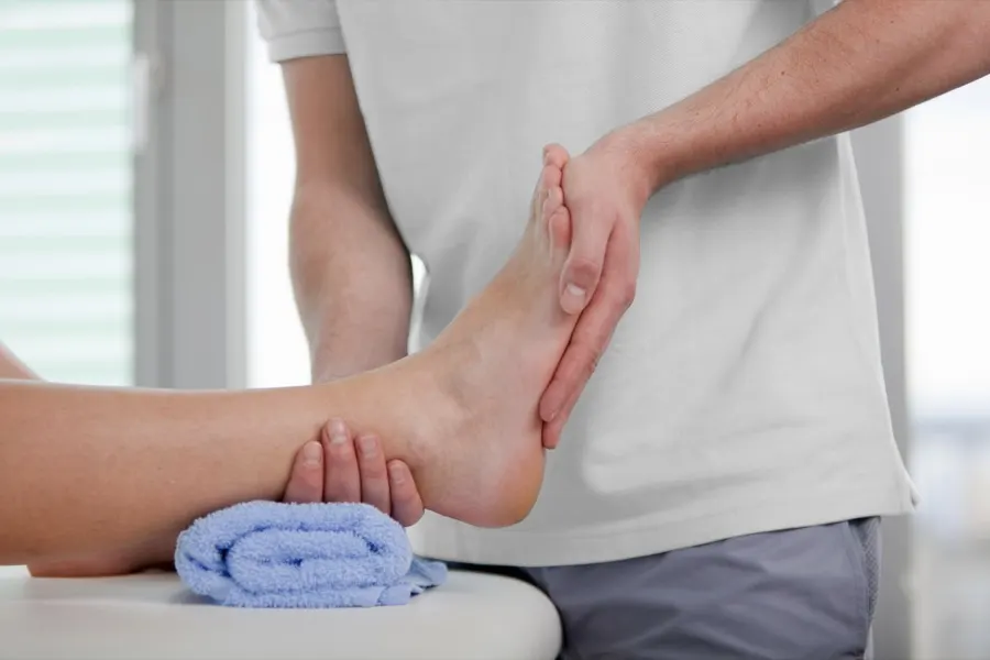 Therapist performing manual therapy on a patient's ankle